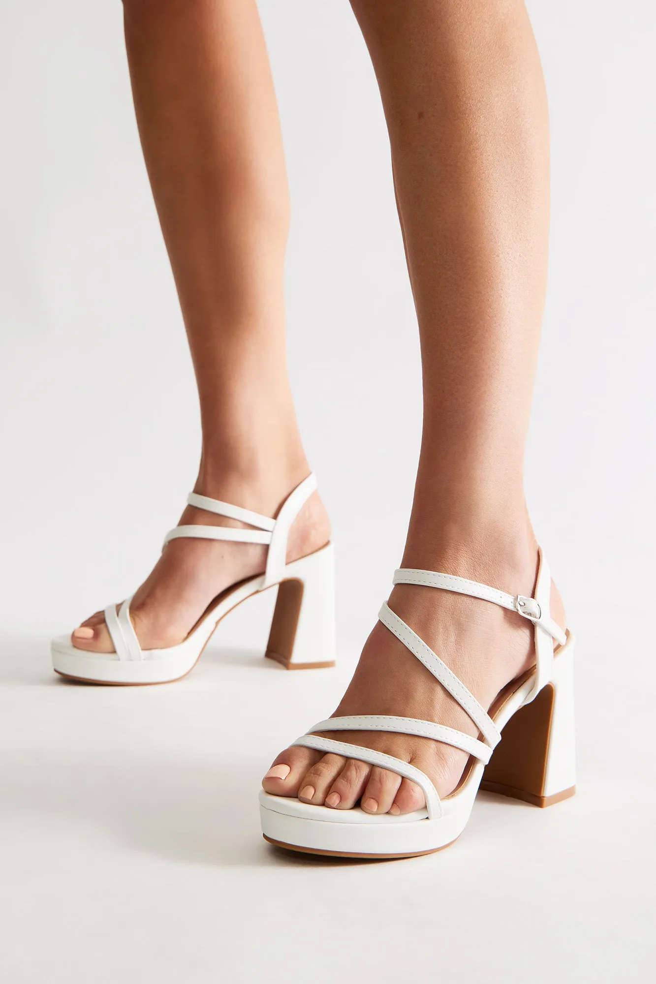Adriel Faux Leather Ankle Strap Heels - White